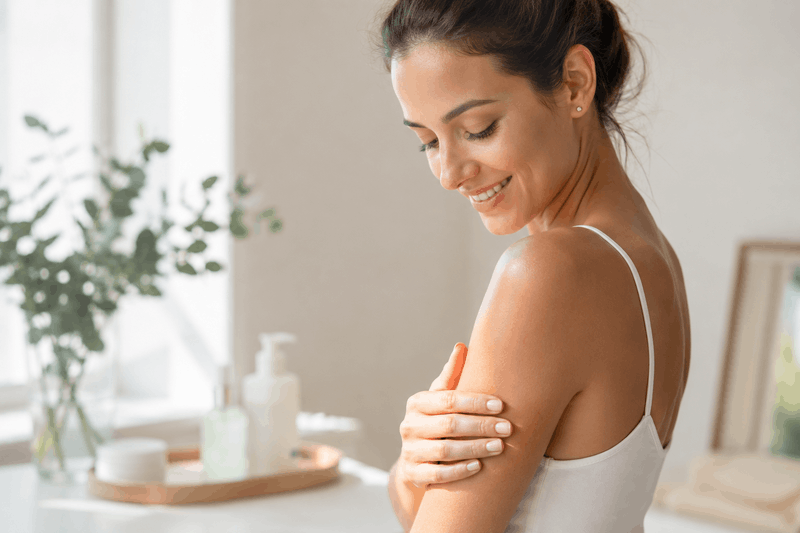 Piel luminosa después del verano Mujer cuidando la piel del brazo para recuperar luminosidad después del verano